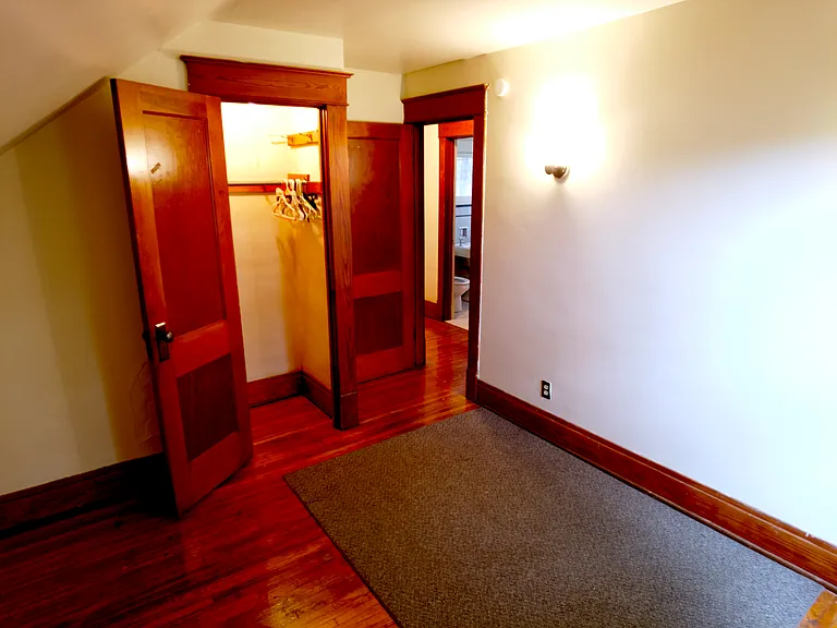 Second bedroom looking into the hallway. The original hardwood floor extends into the spacious closet, which provides plenty of storage.