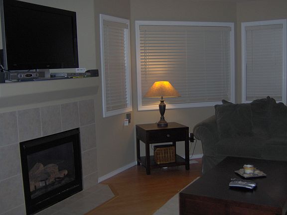Living room with gas fireplace and bay windows