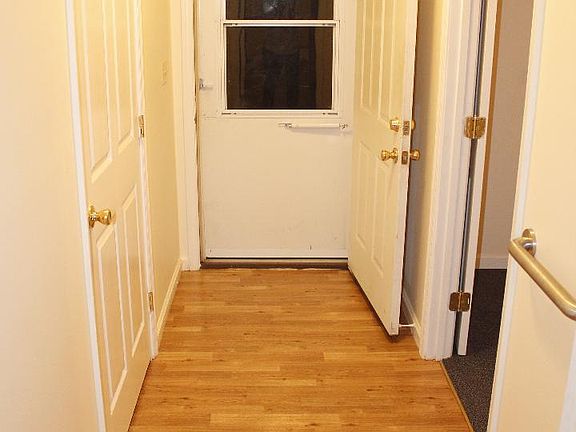 Back hallway. The closed door on the left is Laundry room.  Entry to Bedroom #3 on the right.