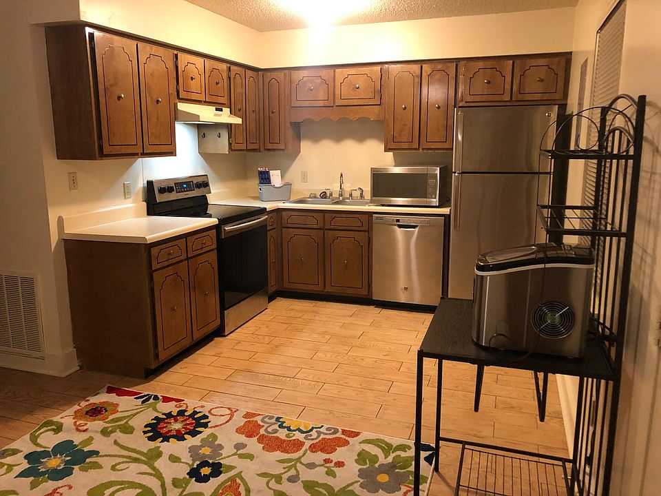 Spacious kitchen with good window light and patio just outside door.