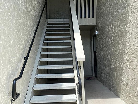 Stairs to the unit located on the right at the top.