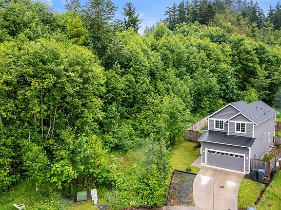 Property is bigger, goes into the woods on your left.>