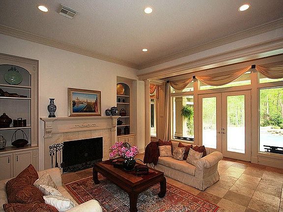 Gorgeous Formal Living Room w/floor to ceiling high windows overlooking pool.