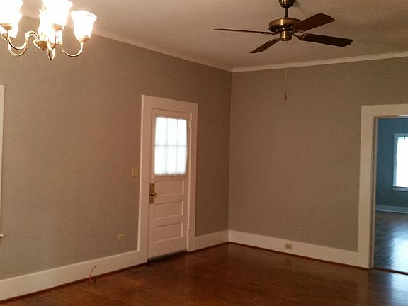Front door in living room and view into bedroom #1