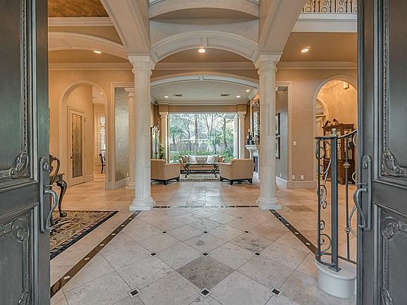 Stunning view from foyer through the formal living room to pool and patio.