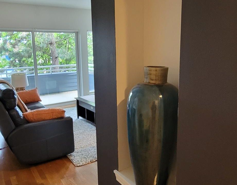 Wide hallways with hardwood floors throughout the home.