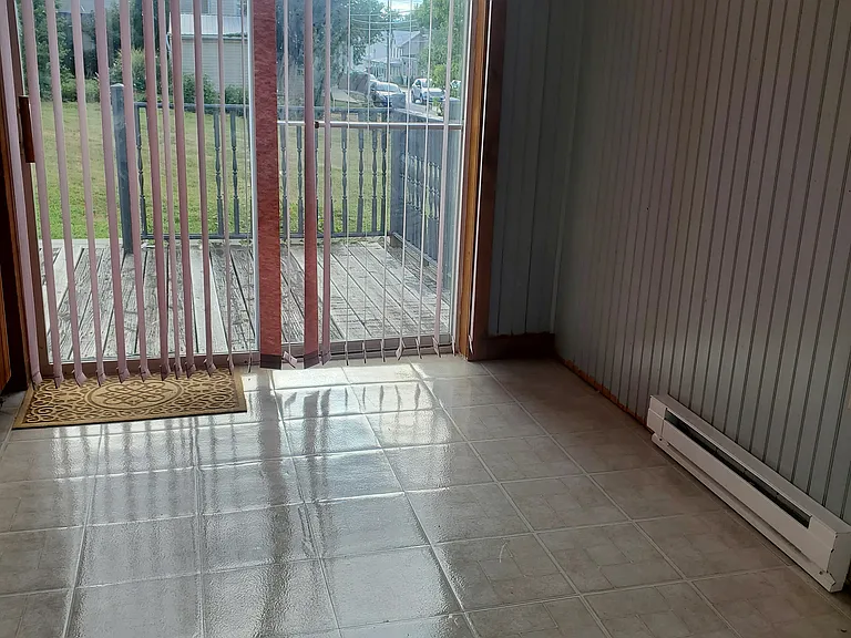 Dining area in a kitchen and access to the deck.