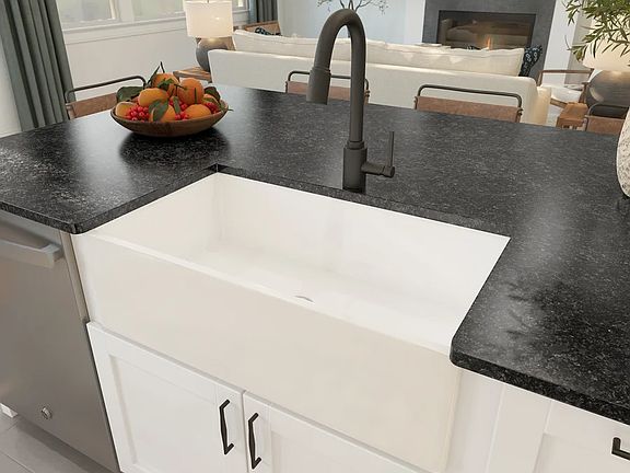 Kitchen with white apron-front sink and matte black fixtures