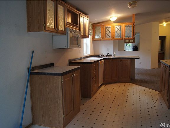 Efficient kitchen with glass front oak cabinets.