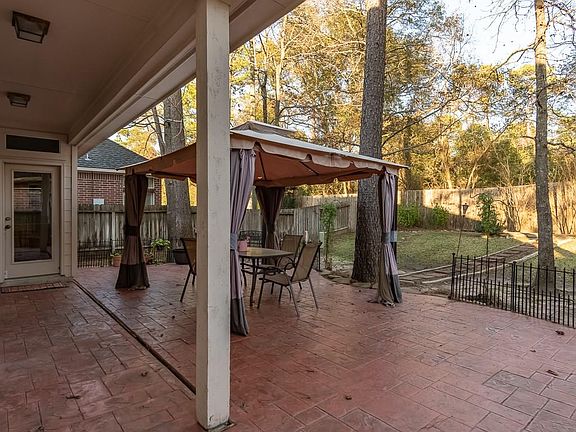 The extended back patio has a cover. The large yard has plenty of room for kids and pets to run.