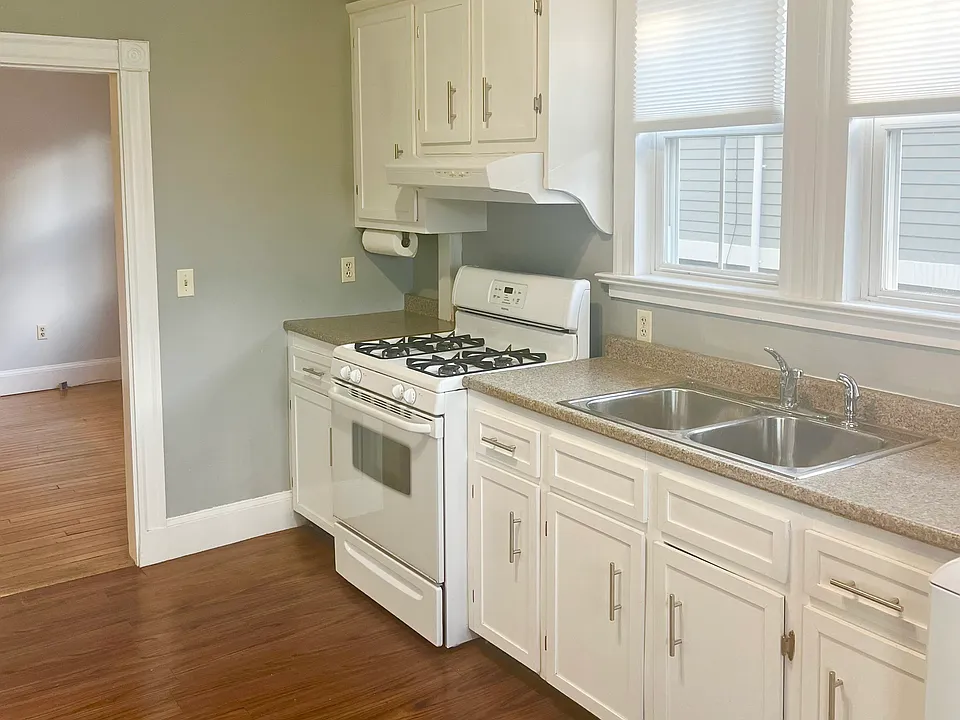 White cabinets, double sink and a gas stove!
