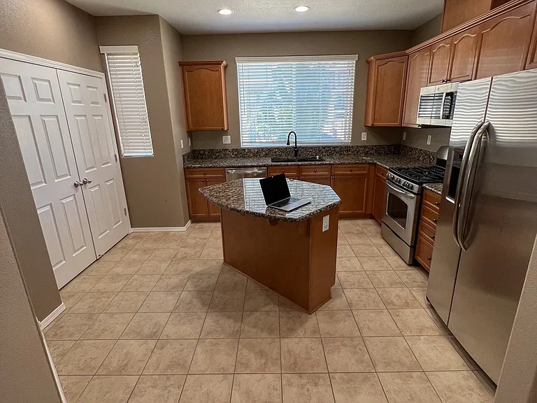 Kitchen fridge, oven, microwave sink & pantry doors... looking into kitchen from dining area.