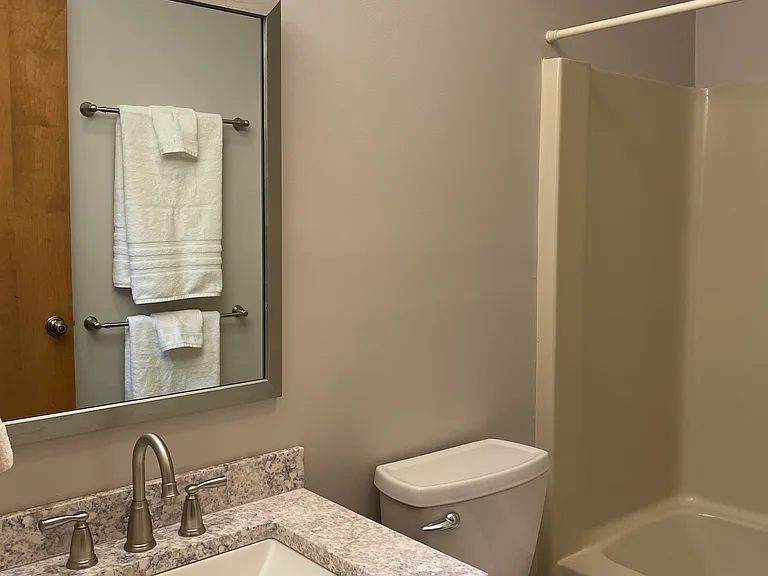 Bath with granite countertop, new mirror and lights.