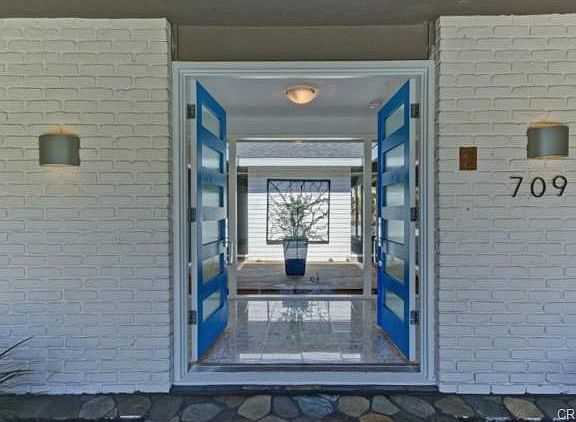 This entrance with covered porch area, terrazzo foyer and atrium