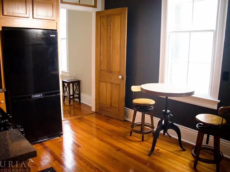 Our comfortable kitchen features gas stove and oven, a stylish pub table, oak cabinetry with black accents and the original light globe from the 1920s!