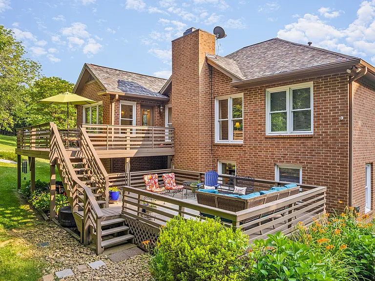 Enjoy the upper patio and lower back deck with beautiful views of the private, wooded backyard.