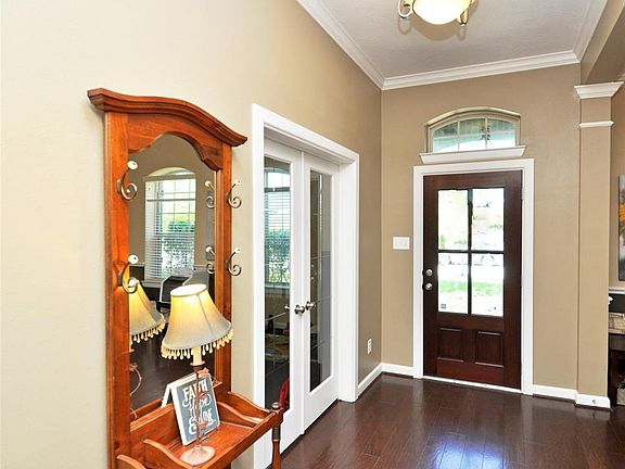 View of elegant entry with nice crown molding, private study (used as play room), and opposite side is formal dining room.