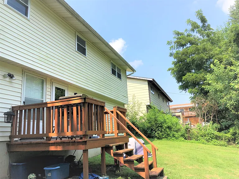 The rear of the property has a small shared deck and yard.