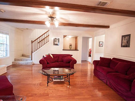 Wood floors continue to the family room which boasts exposed wood beams.