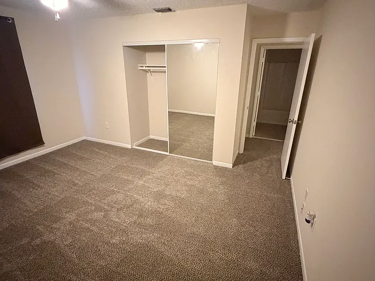 all bedrooms have carpet with mirrored closets. also have blinds and curtains.