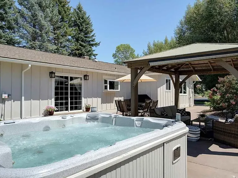 Dreamy backyard! Covered pergola, amble seating, surrounded by cottonwoods!