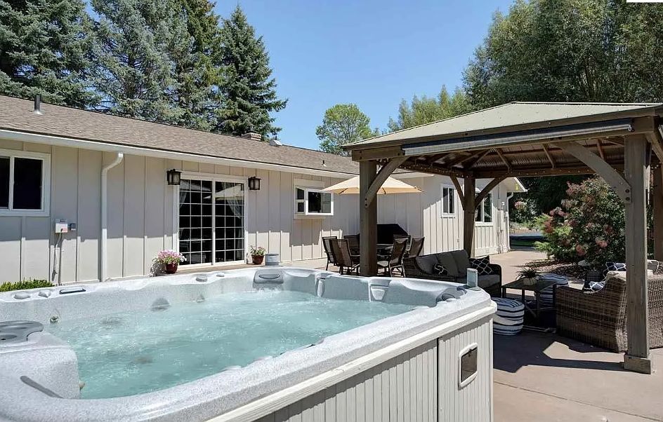 Dreamy backyard! Hot tub, covered pergola, amble seating, surrounded by cottonwoods!