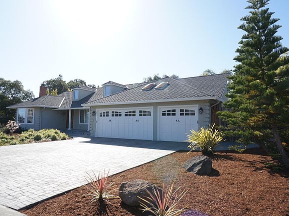 Large 3 car garage with newer carriage roll up doors