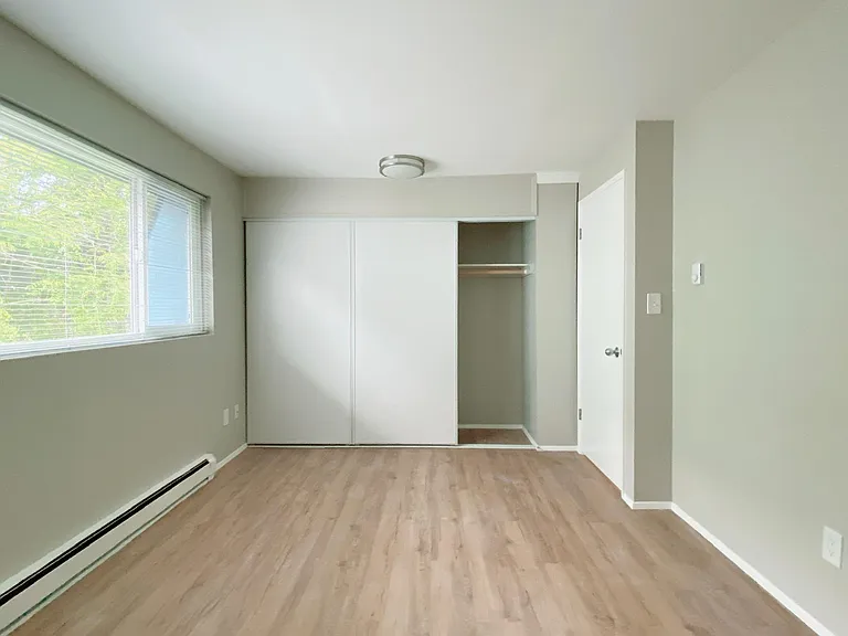 Bedroom 1 - large, deep closets. Space can easily accommodate a large double/queen bed with desk