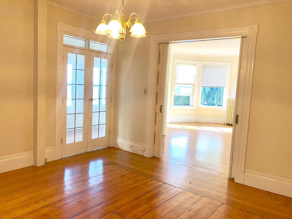 Dining room with french doors leading into sunroom.