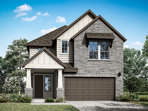 A two-story house with a stone exterior, a gabled roof, and a garage door in the foreground, surroun