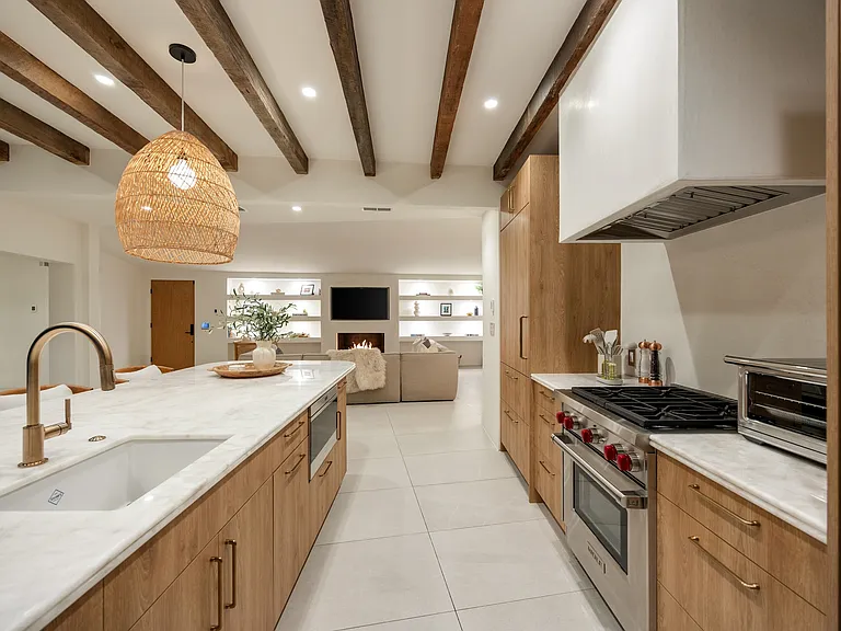 A spacious island with a brass faucet is perfect for prepping, serving, or gathering.