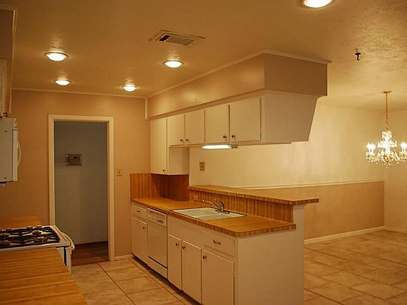 Efficient Kitchen with recessed lighting, bright white cabinets, new hardware, Gas Range with DOUBLE OVENS, built-in microwave, and spacious pantry. A Recipe for Success!