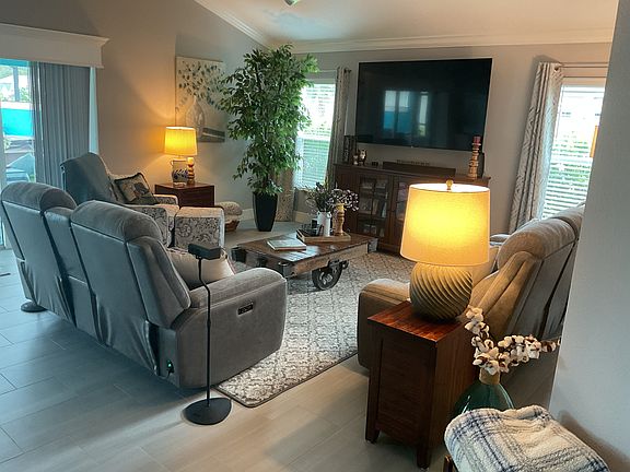 View of living room as you enter from foyer. 4 reclining seats here with a new 75 inch television.