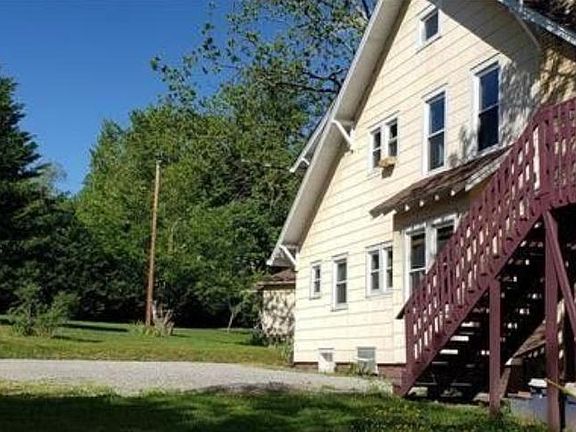 Front side view showing lawn and parking