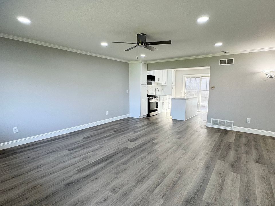 View from front door into kitchen. Recessed lighting throughout.