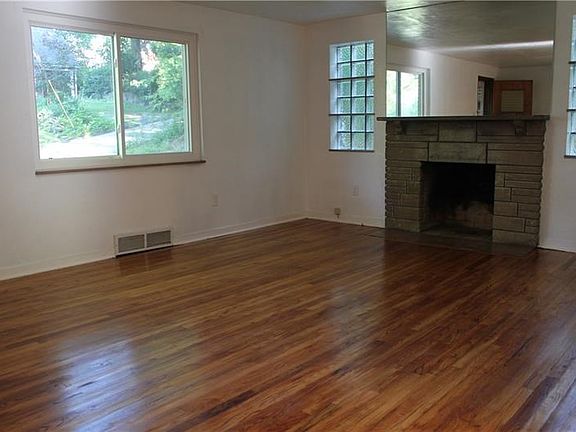 Notice the large window providing lots of light and charming fireplace.