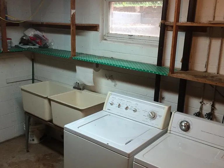 Full Utility room with washer/dryer and utility sink.
