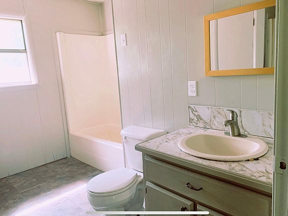 Wet room includes full bath setup, separate stand in shower, washer and dryer hookups, and water heater closet