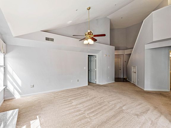 Spacious living space with open living room, separate dining room, gas marble fireplace, and wall mount for TV.