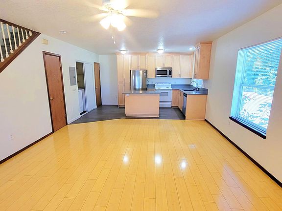 Living room with view into kitchen