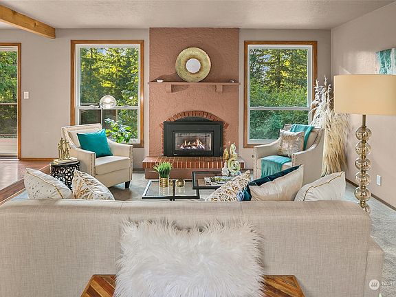 Living room with a gas fireplace, just off a deck and the dining area.>