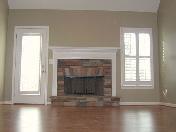 Great Room w/HW floors,stone FP, custom plantation shutters & cathedral ceilin