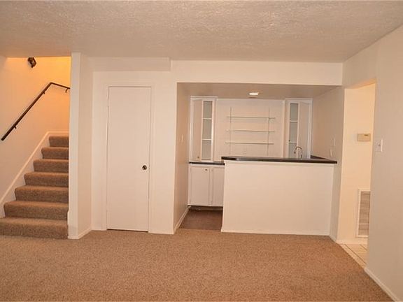 View of wet bar and staircase.