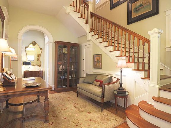 Truly wonderful foyer shown here. This staircase is divine and arched doorways beckon to the other rooms.