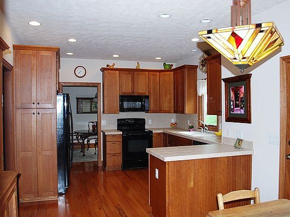 Spacious Kitchen with quarter-sawn oak cabinets and tile counter-tops 