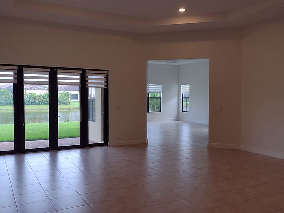 Spacious living room/dining room with open view into family room. Photo taken prior to back-yard landscaping.