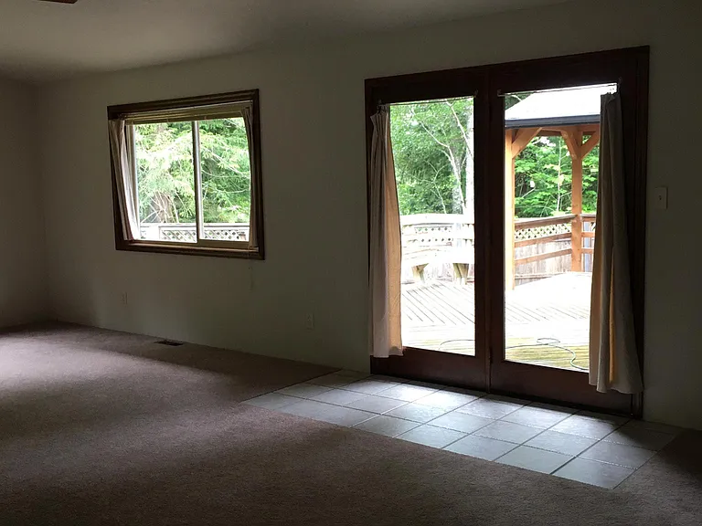 Front room with vaulted ceilings and exterior access to deck and gazebo