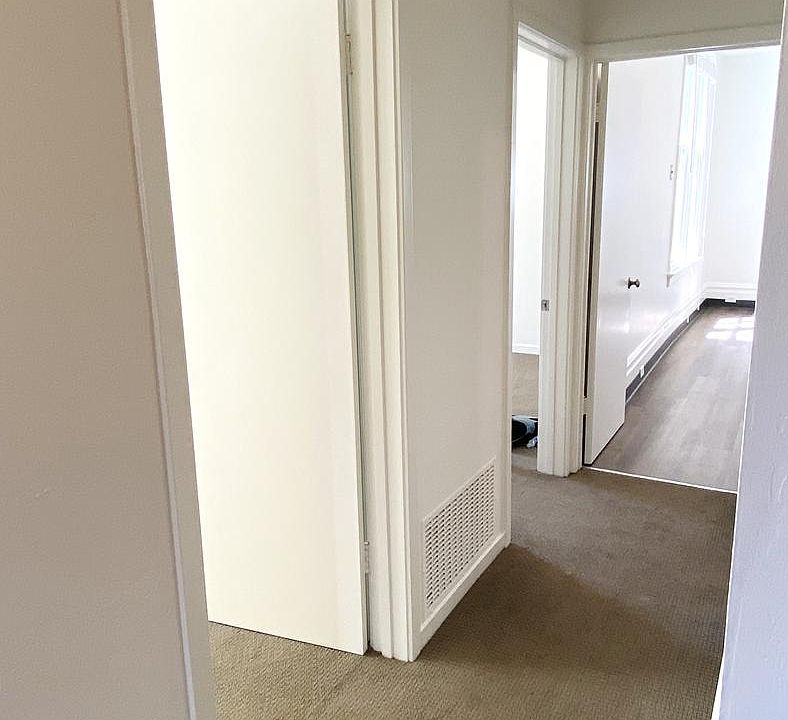 Main Hallway: Bedroom #2 and #3 are on the left. Bathroom is on the right. The hallway leads into the Kitchen.
