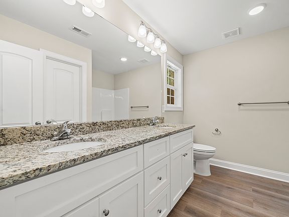 Primary bathroom with granite counter tops and dual sinks