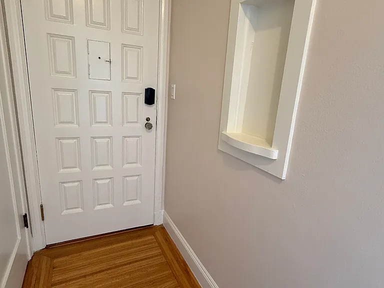 Exit view of front door with keyless locking system and period detail wall shelf. (Main walk-in closet is outside the pic on the left). All brass door hinges are brand new!